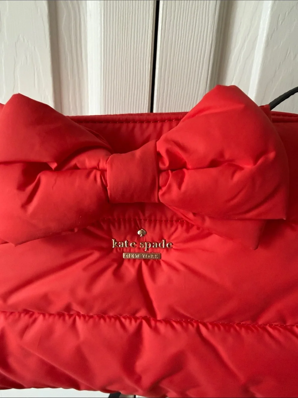 kate spade red quilted crossbody with bow and black strap